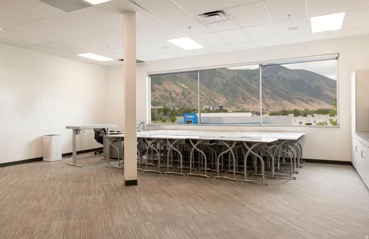 Expansive room with large windows offering a mountain backdrop