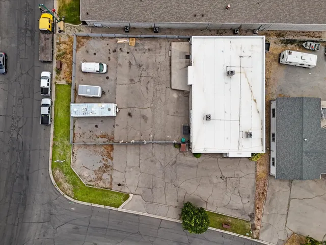Commercial building with a white flat roof and multiple rooftop HVAC units
