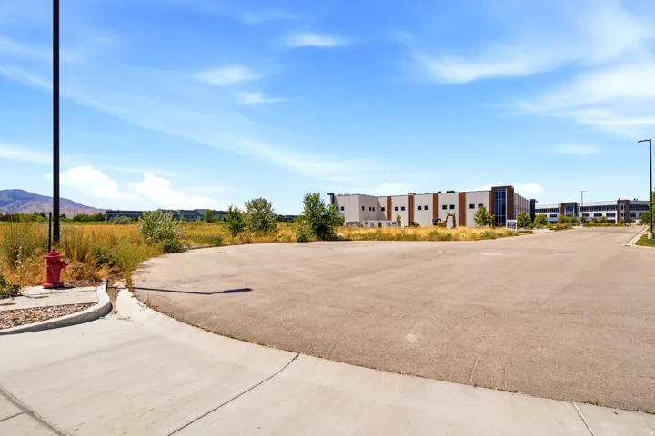 Paved lot with curbed edges, a light pole, and a fire hydrant