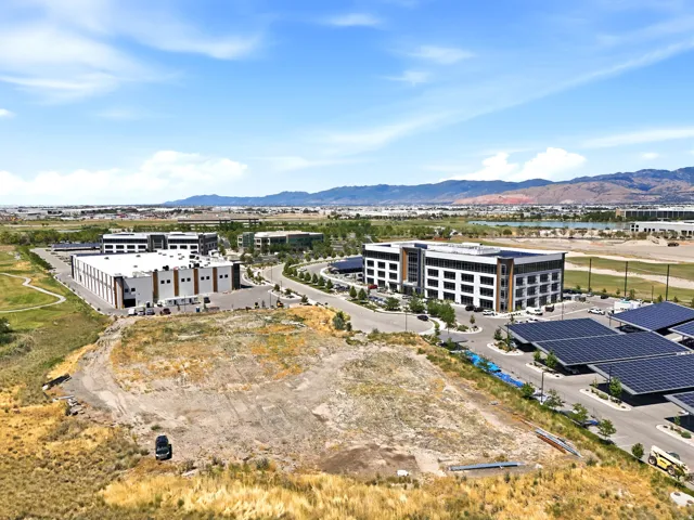 Expansive undeveloped land parcel with surrounding commercial properties