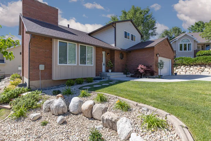 Brick exterior with multi-pane windows and a distinct chimney feature