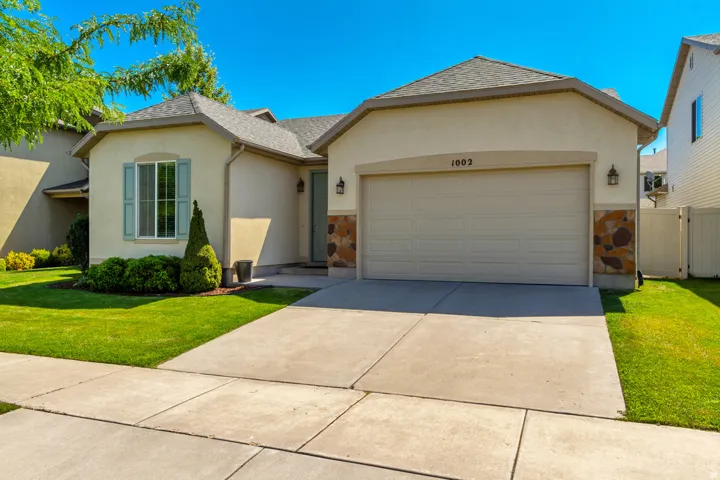 Stucco exterior with stone accents and a two-car garage