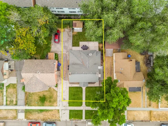 Aerial property perspective featuring a gabled roofline and an expansive rear yard with a patio area