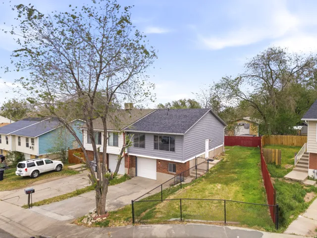 Gray siding exterior with a dark shingle roof
