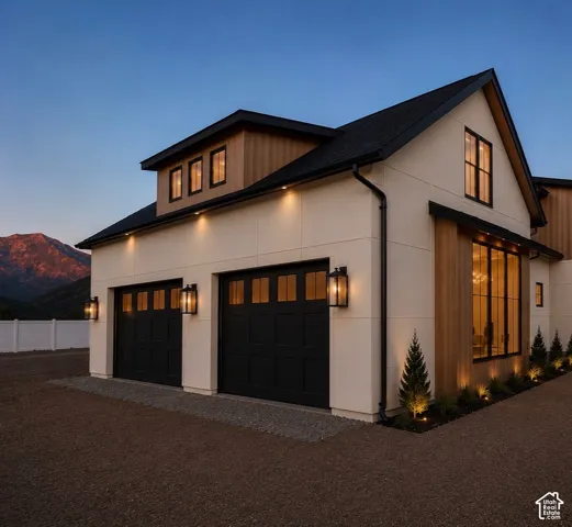 Contemporary architectural design featuring a crisp white exterior with natural wood accents and a dark-pitched roof