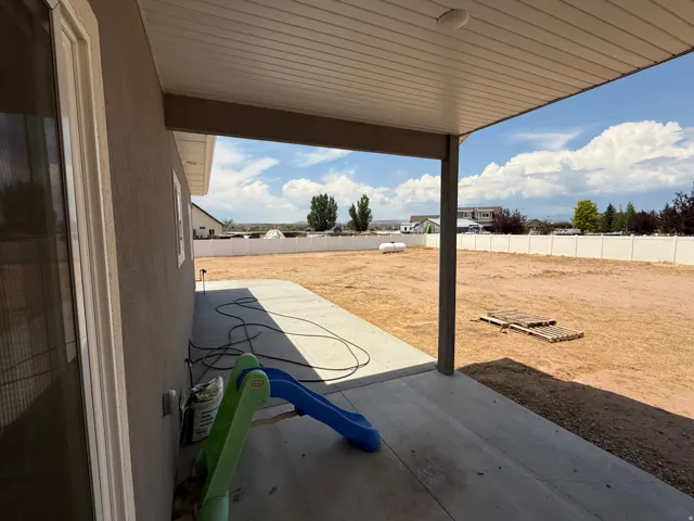 Spacious covered patio with a textured stucco exterior