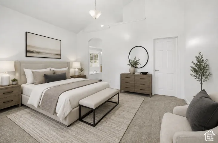 Vaulted ceilings, archway entry, and warm neutral tones throughout