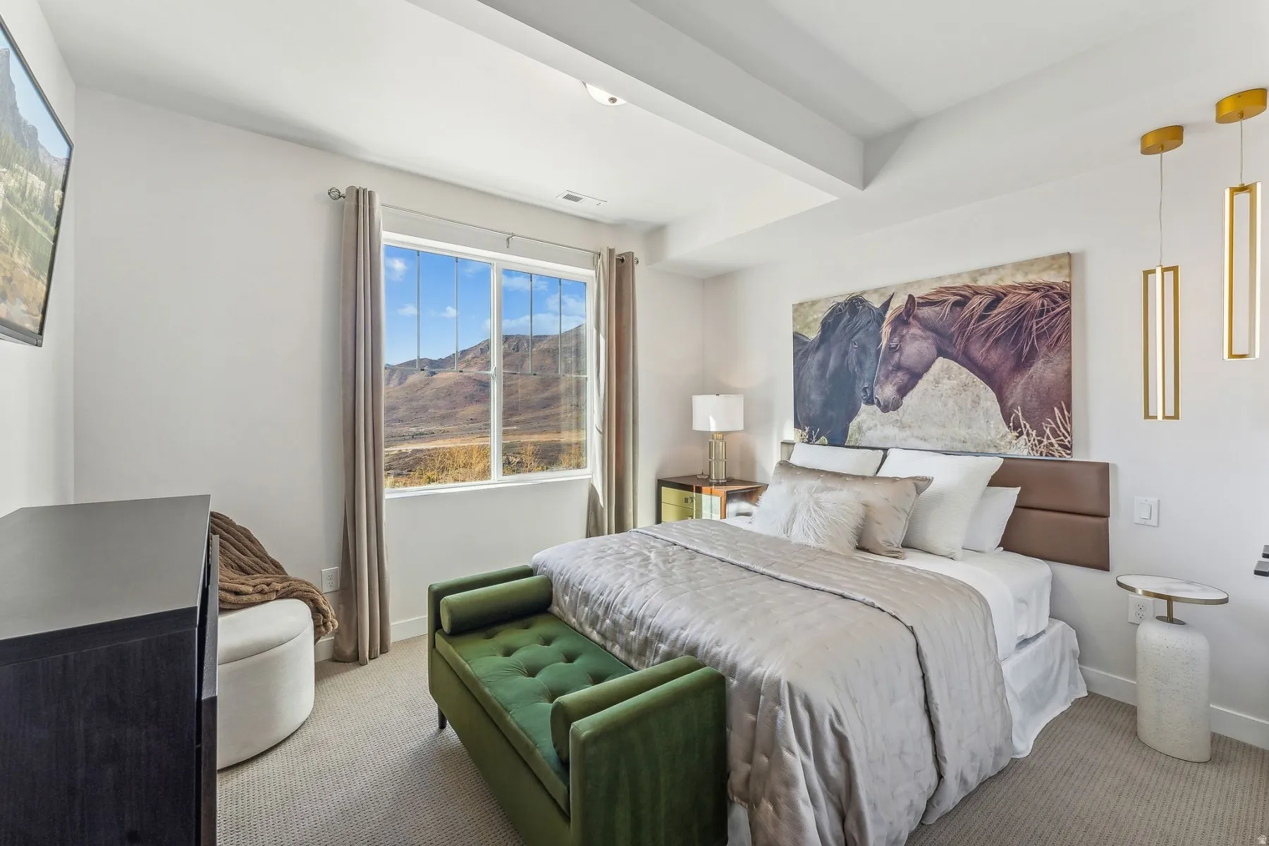 Spacious bedroom featuring a large window with mountain scenery, recessed lighting, tray ceiling, and carpeted flooring