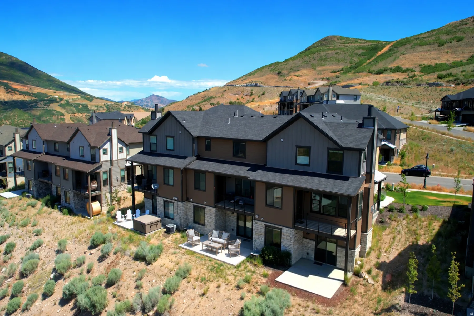 Contemporary multi-story exterior with dark siding and stone accents
