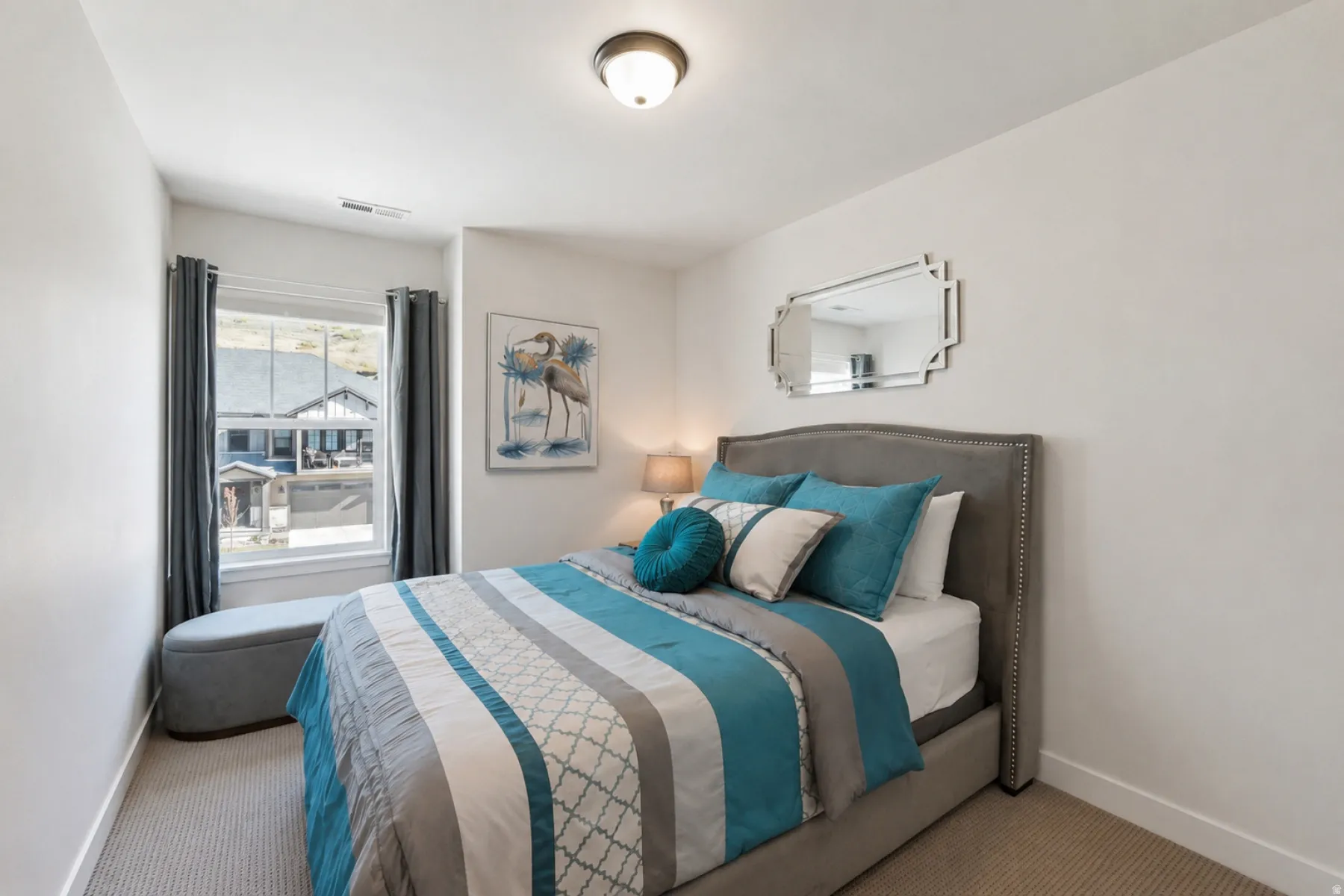 Neutral wall paint, recessed window with dark drapes, ceiling-mounted light fixture, and carpeted flooring