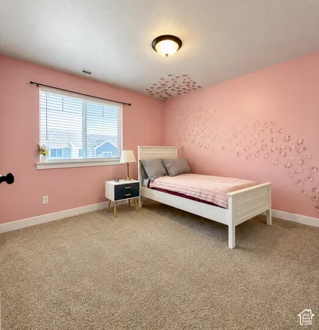 Room featuring plush carpet flooring, a large window with white blinds, and a flush mount ceiling light fixture