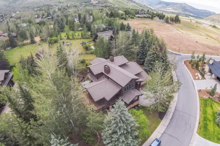 Multi-level residential property featuring a brown exterior and multi-pitched roofline