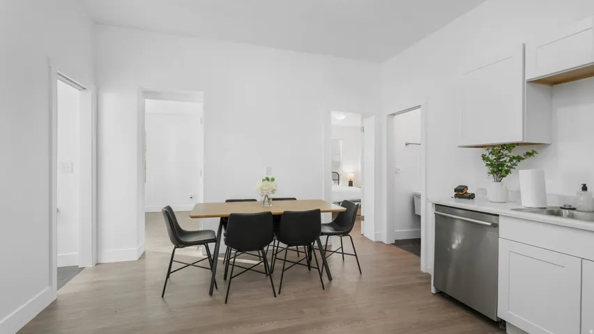 Modern kitchen area featuring white cabinetry and stainless steel appliances