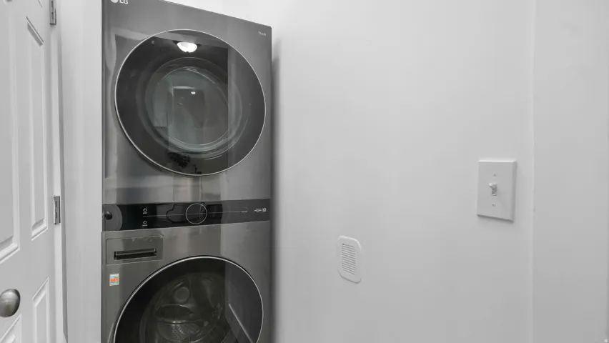Stacked laundry appliances in a dedicated utility space