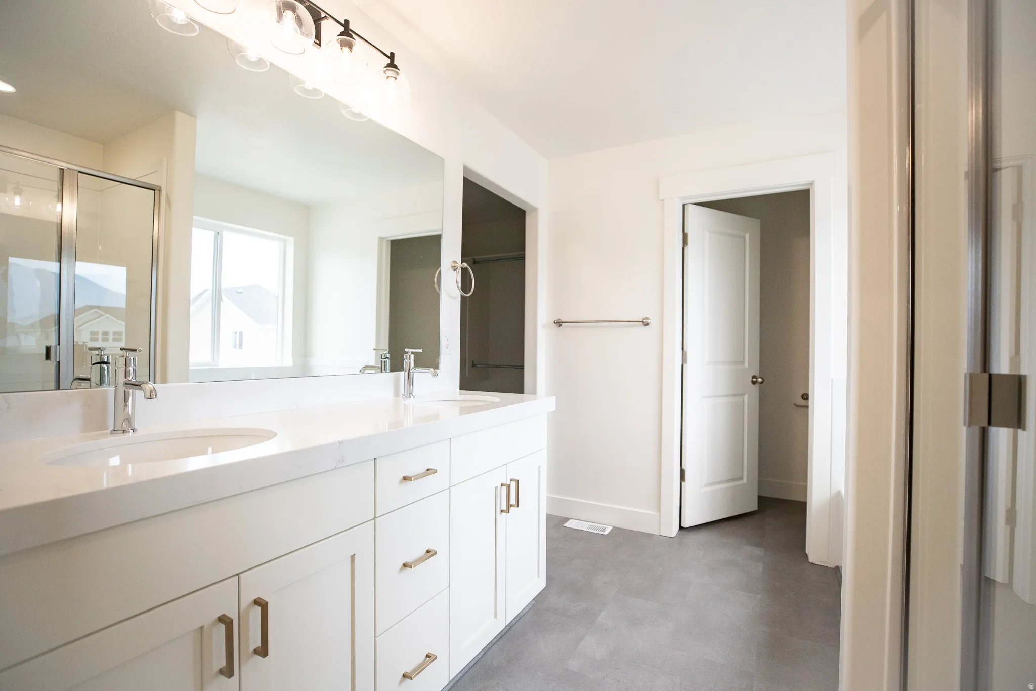Primary bathroom featuring dual vanity and separate tub and shower