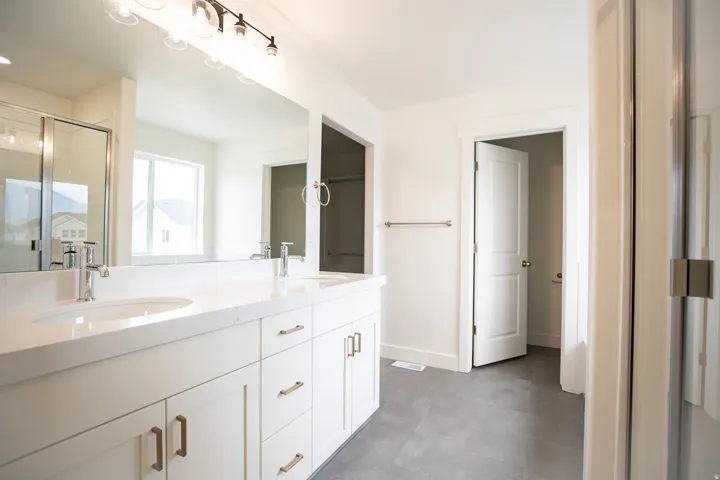 Primary bathroom featuring dual vanity and separate tub and shower