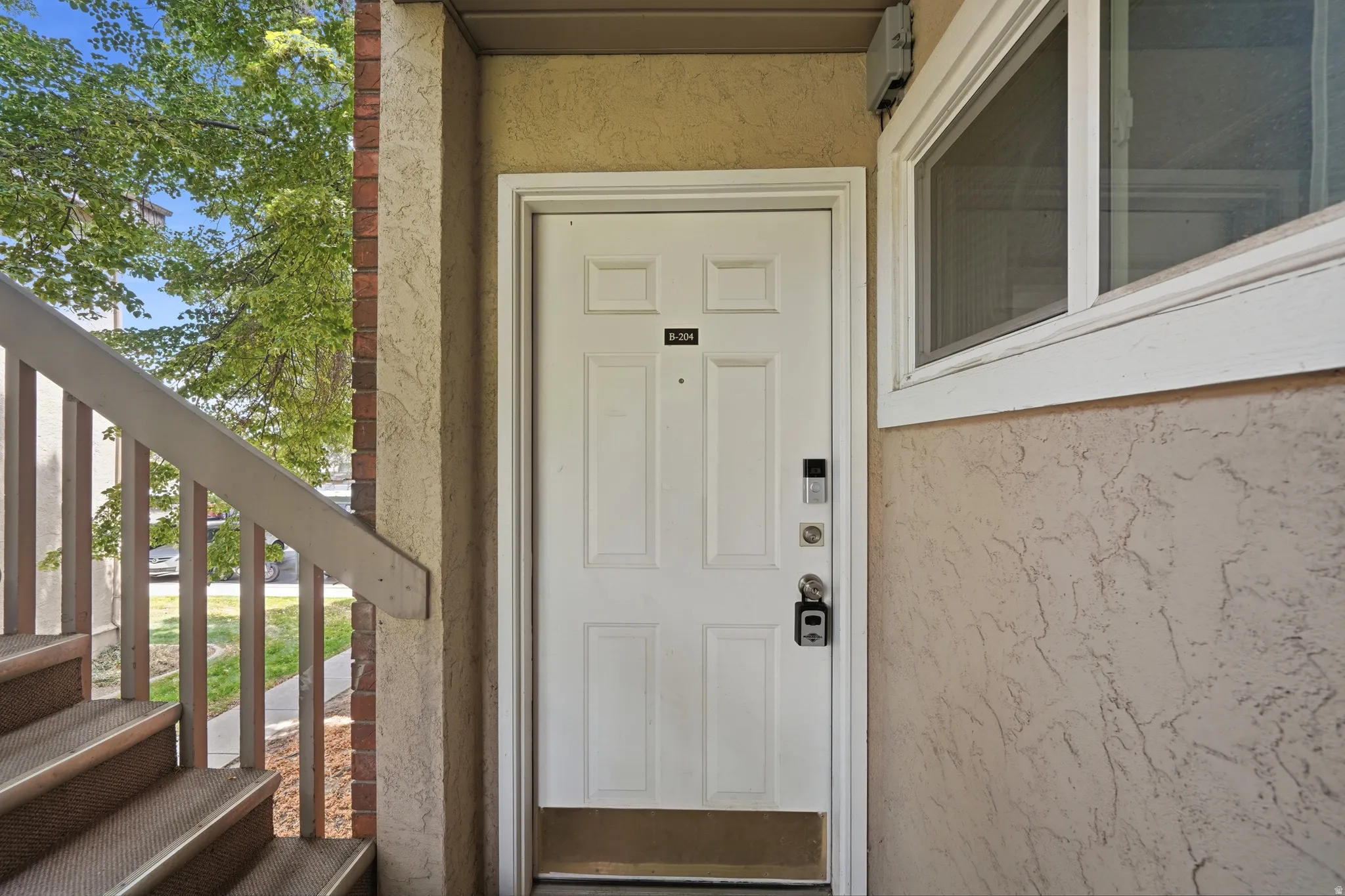 Entry door featuring panel detailing and modern smart lock hardware