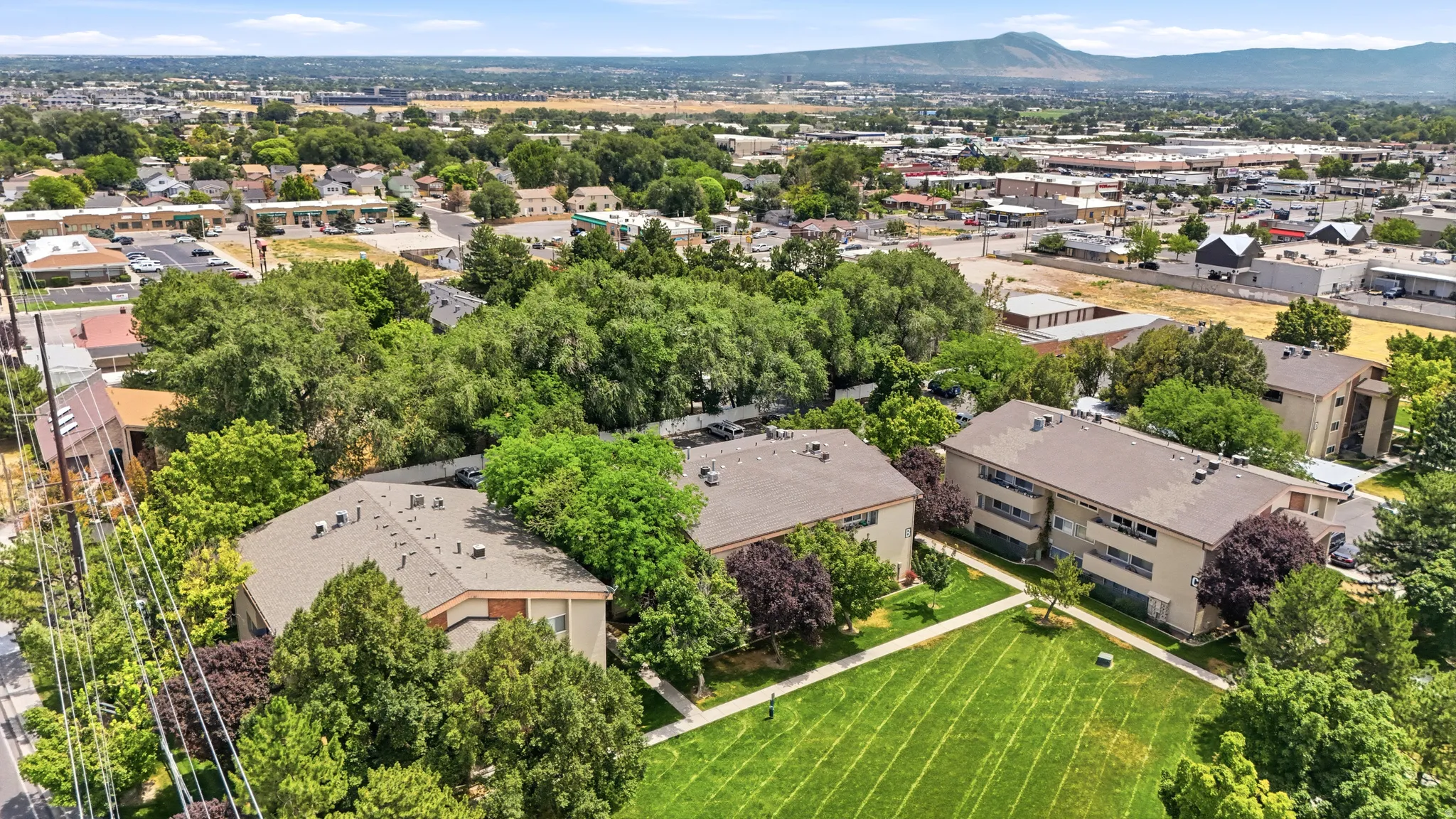 Expansive aerial perspective showcasing multiple apartment buildings featuring neutral-toned facades