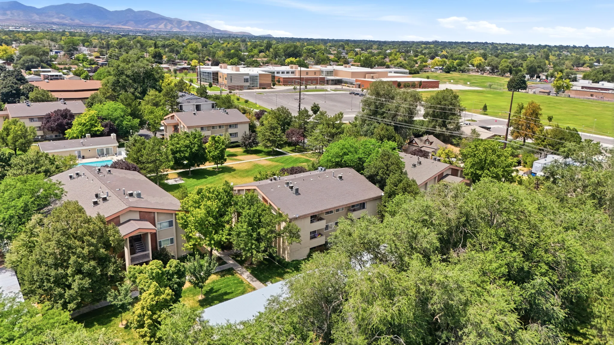Aerial perspective showcasing multiple multi-story residential buildings with pitched roofs