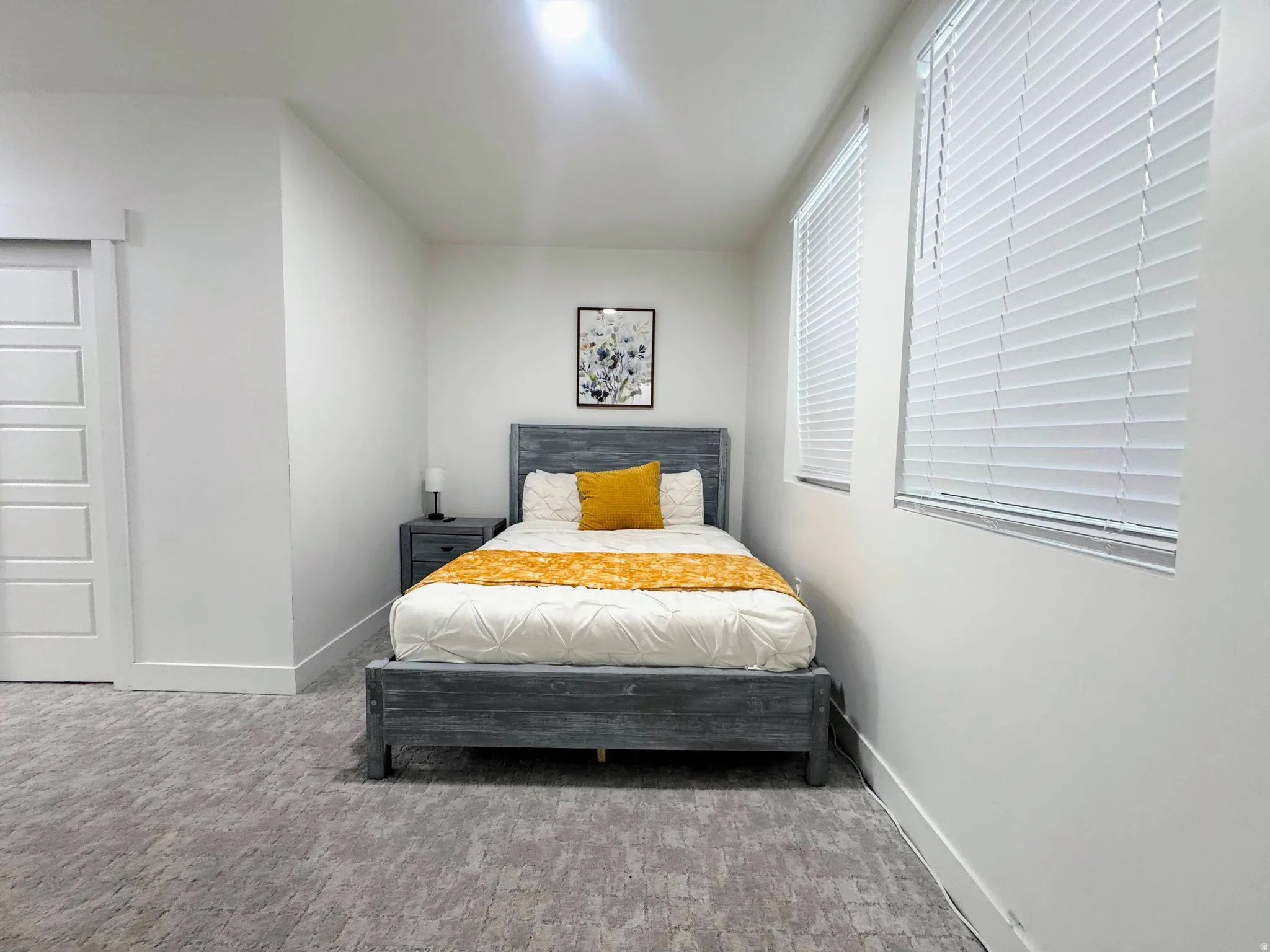 White paneled walls with a textured gray carpet