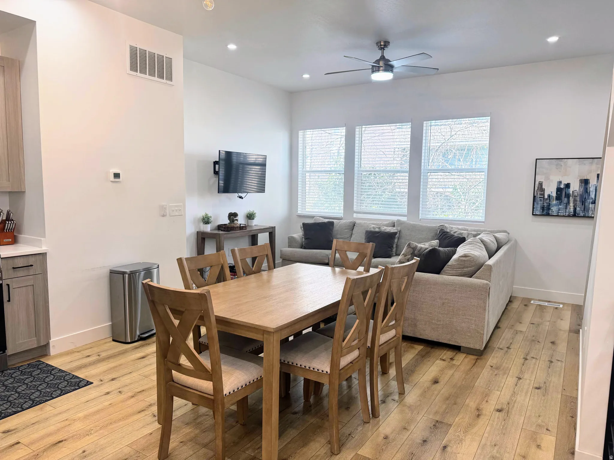 Spacious living area featuring wood-finish flooring, recessed lighting, and a ceiling fan