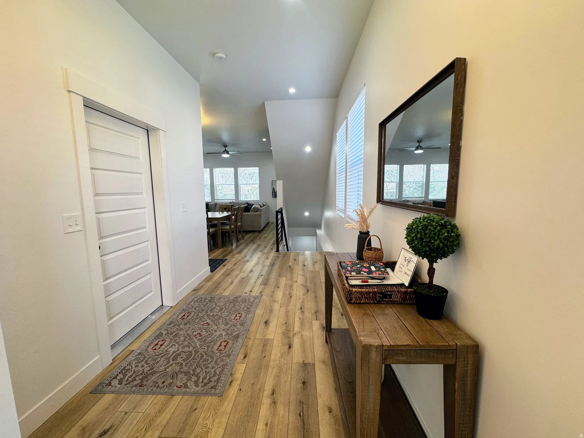 Light wood-finish flooring extending through the entry hall