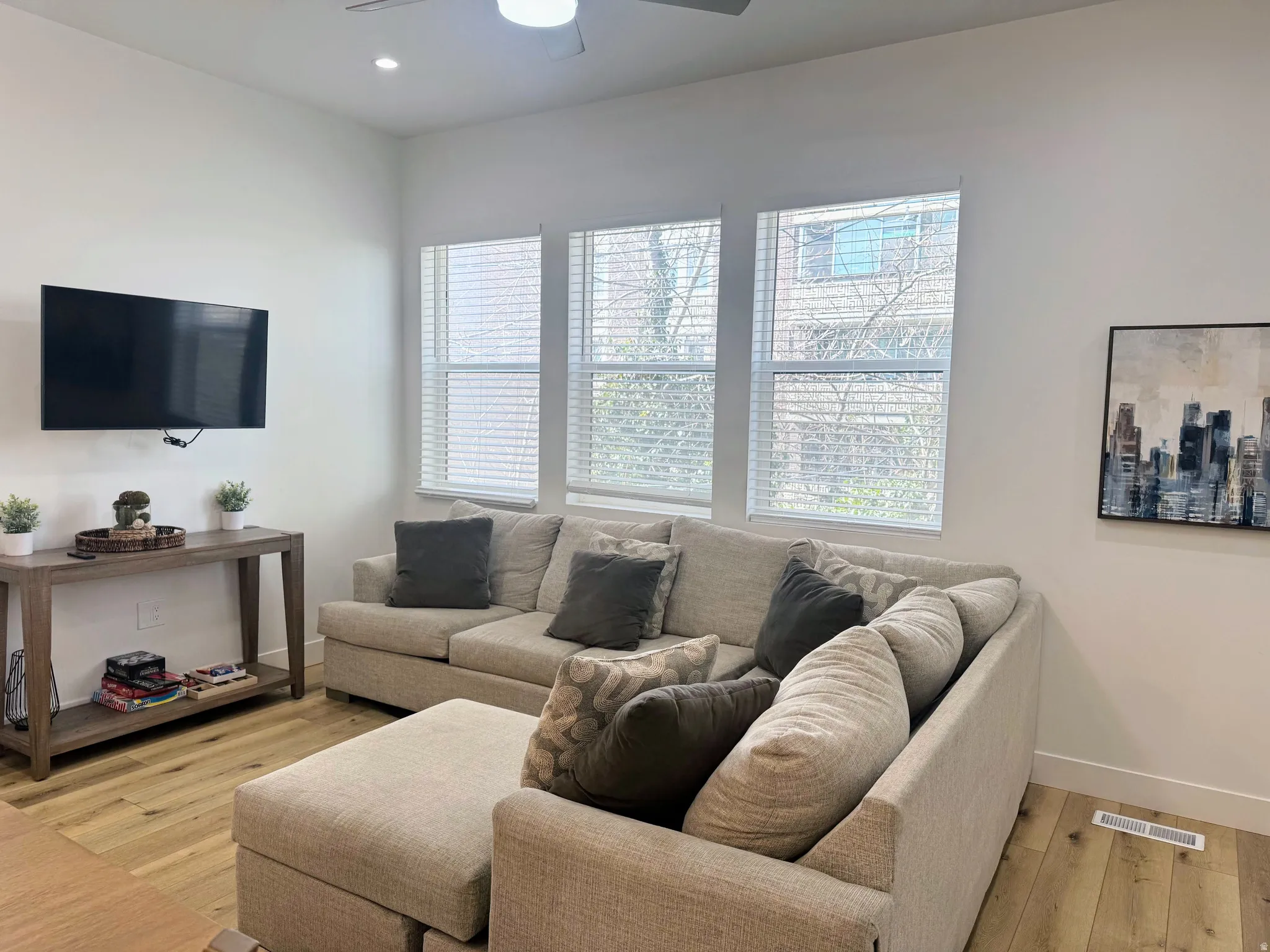 Living area featuring light wood-finish flooring and white walls