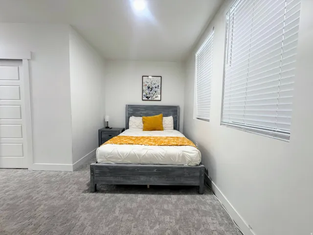 White paneled walls with a textured gray carpet