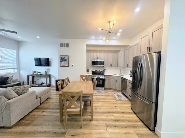 Open-concept living space featuring wood-finish flooring throughout