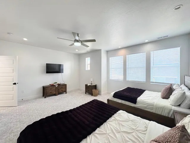 Spacious interior featuring light-toned carpeting and white walls