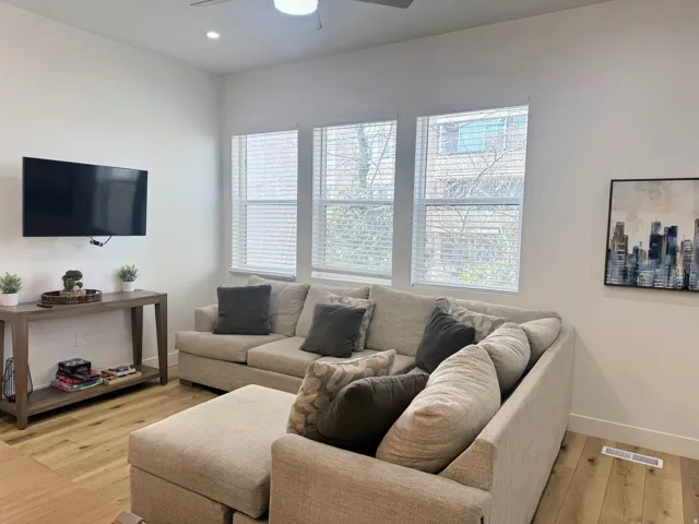 Living area featuring light wood-finish flooring and white walls