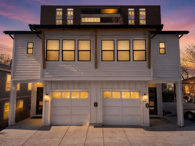 Contemporary duplex exterior featuring white horizontal siding and board and batten accents