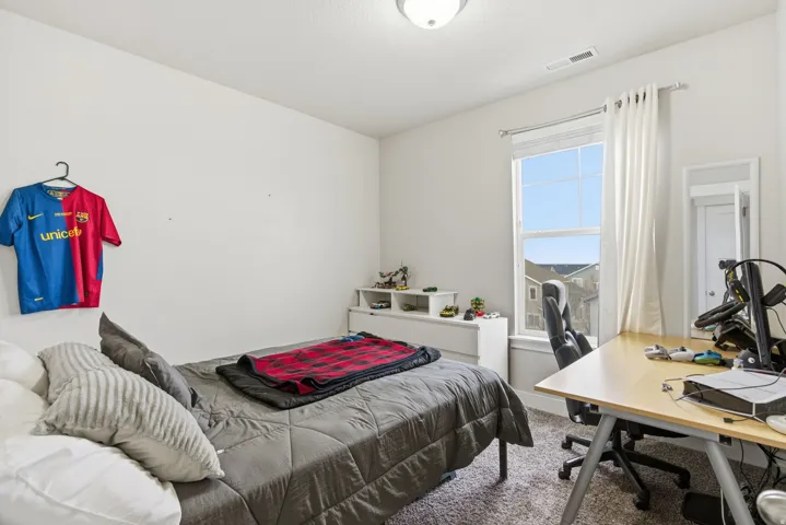Carpeted room featuring a white ceiling, a single window with white trim, and a flush-mount ceiling light fixture