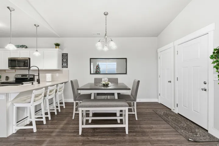 Open-concept kitchen and dining area featuring wood-finish flooring
