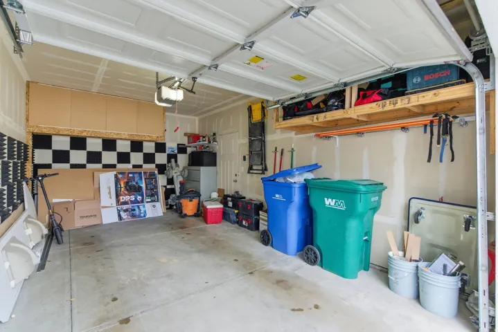 Attached garage with concrete flooring