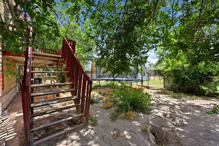 Exterior wood staircase providing access to an upper level