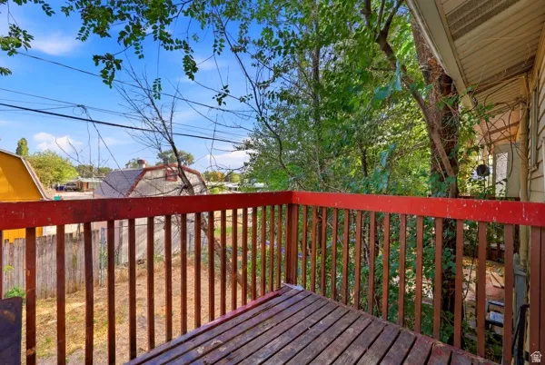 Exterior deck with wood-finish decking and red-painted wood railing