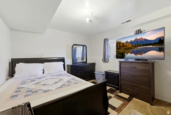 Carpeted room with white walls and a ceiling-mounted light fixture