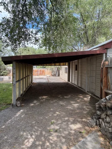 Carport structure featuring a metal roof and open wood framing