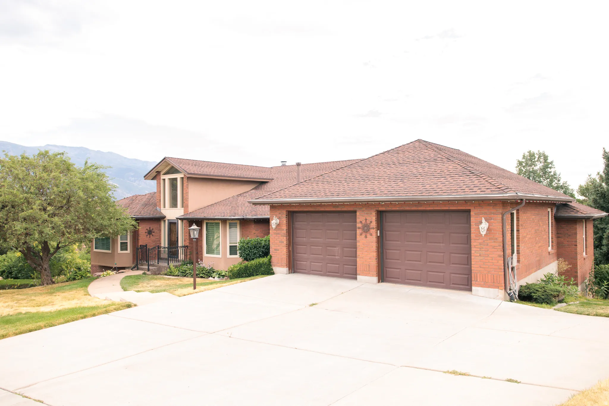 Brick and stucco exterior with a prominent two-car garage