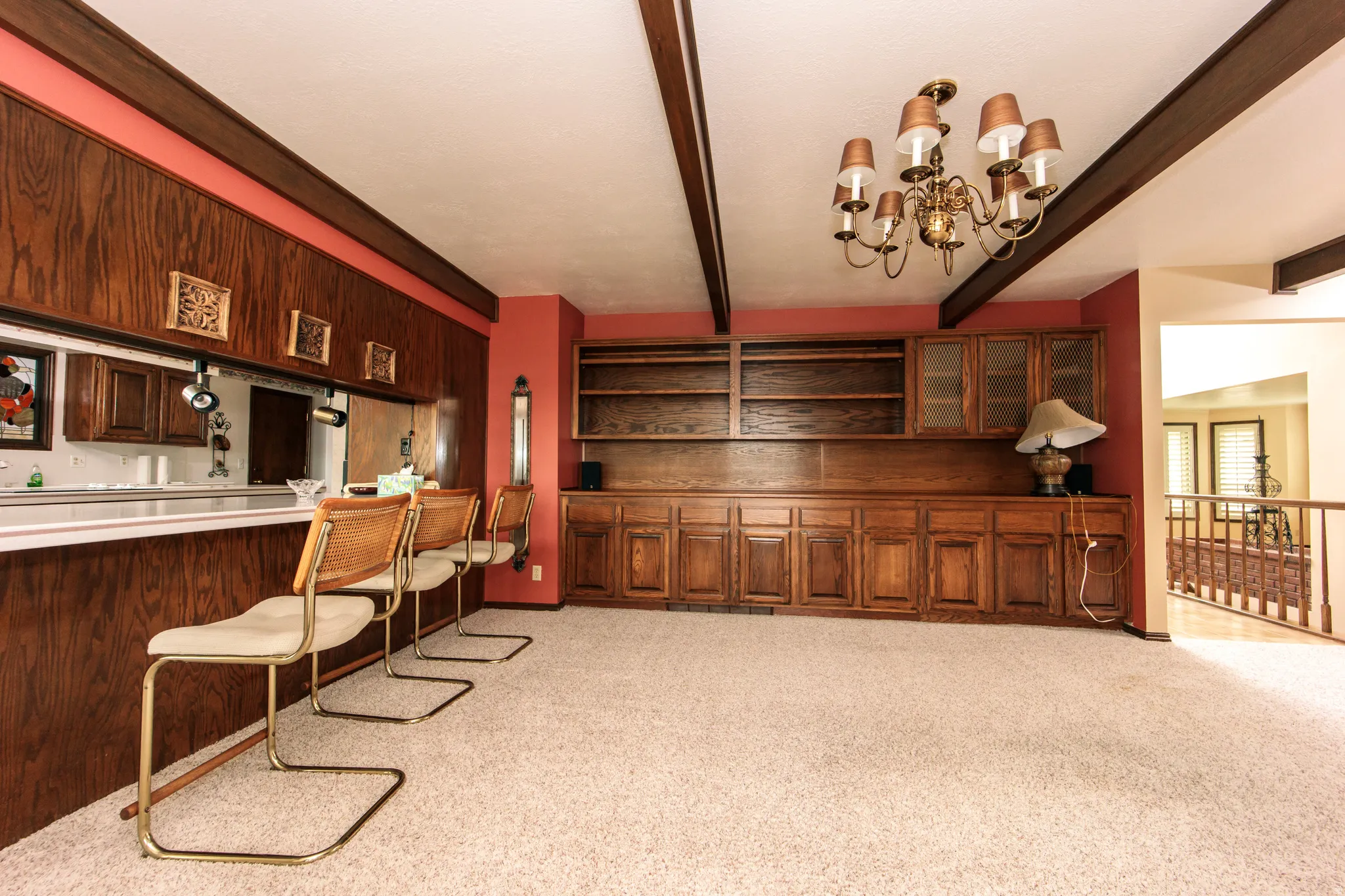 Wood-paneled bar with a white countertop and pass-through window