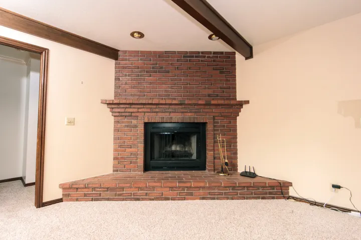 Brick fireplace with a black firebox and a wide, raised hearth