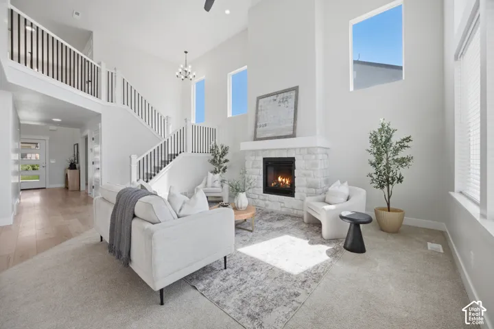 Two-story living area with a stone-clad fireplace and wood-finish flooring