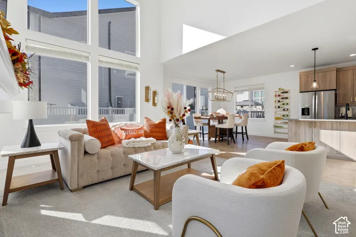 Open-concept living space anchored by floor-to-ceiling windows flooding the interior with natural light