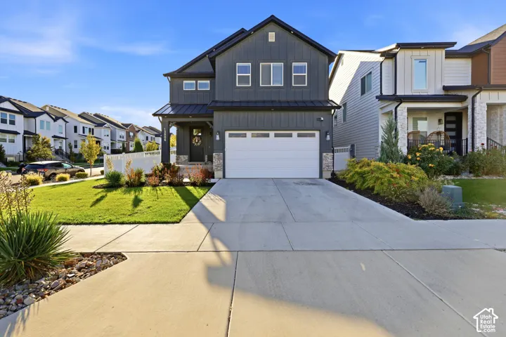 Modern farmhouse-style exterior with dark siding and white trim