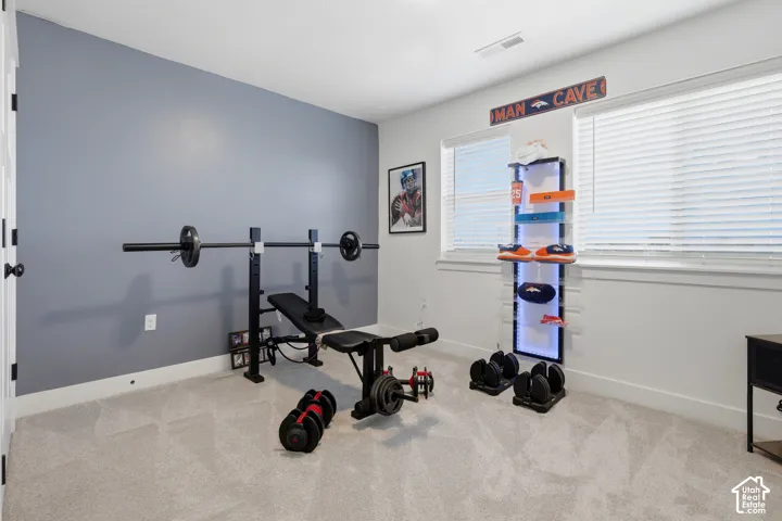Wall-to-wall carpeting and multiple windows with blinds