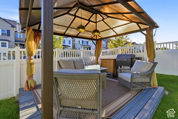 Outdoor gazebo featuring a translucent roof, a raised deck, and integrated lighting fixtures