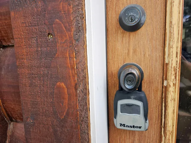 Wood entry door with visible grain and a dark finish