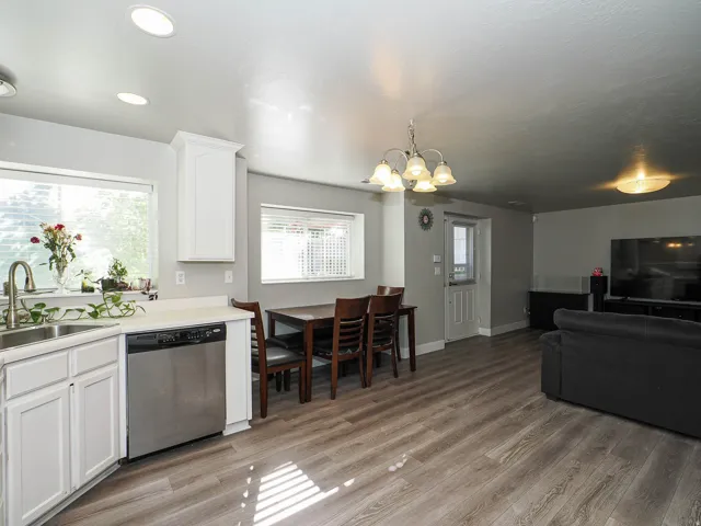 Kitchen featuring white cabinetry, stainless steel sink, and stainless steel dishwasher