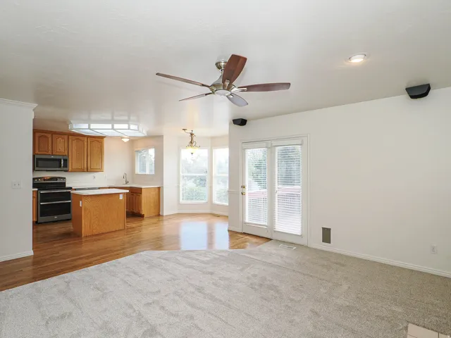 Kitchen with light wood cabinetry, stainless steel appliances, and an island